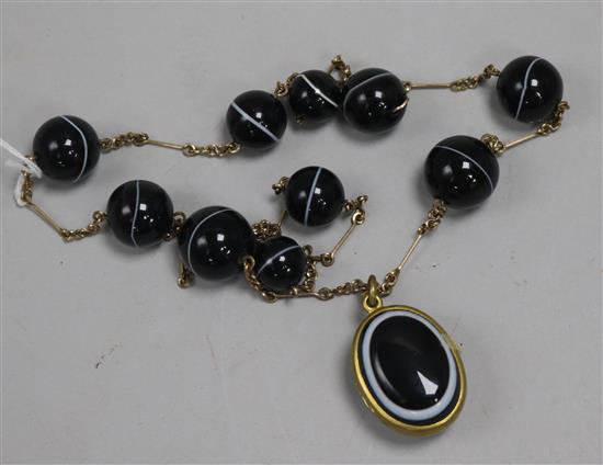 A 19th century gilt metal and banded agate pendant locket, now suspended from a similar necklace.